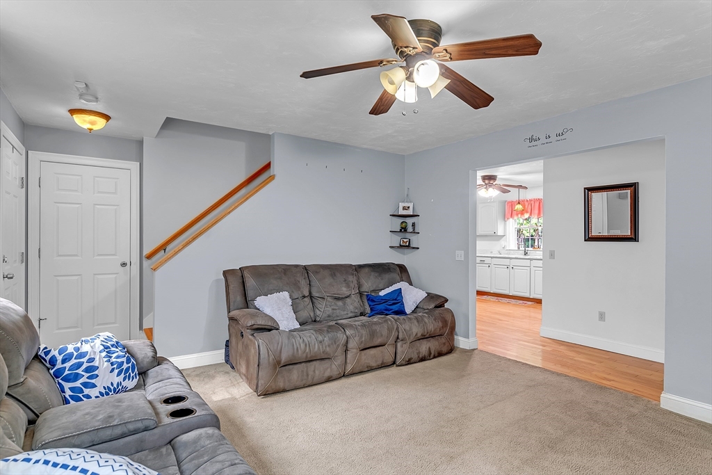185 Bemis Road Warren, MA 01585 - Photo 11 of 36 a living room with furniture and a chandelier