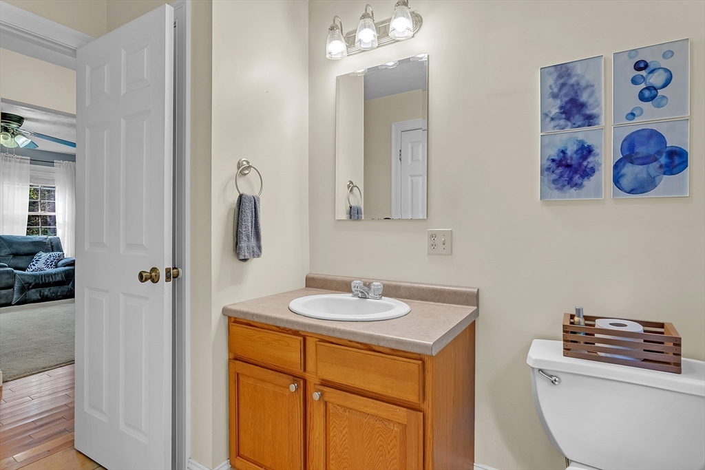 185 Bemis Road Warren, MA 01585 - Photo 15 of 36 a bathroom with a granite countertop sink a toilet and a mirror