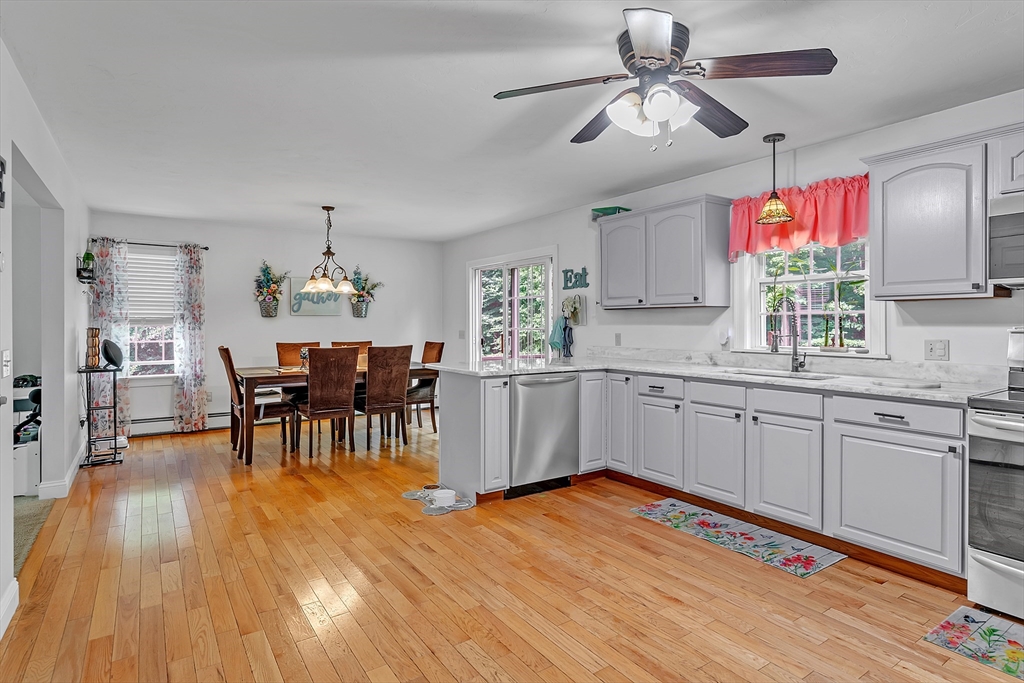 185 Bemis Road Warren, MA 01585 - Photo 2 of 36 a kitchen with stainless steel appliances granite countertop wooden floors sink and cabinets