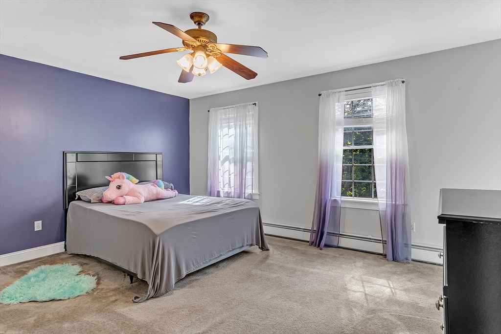 185 Bemis Road Warren, MA 01585 - Photo 21 of 36 a bedroom with a bed and a chandelier