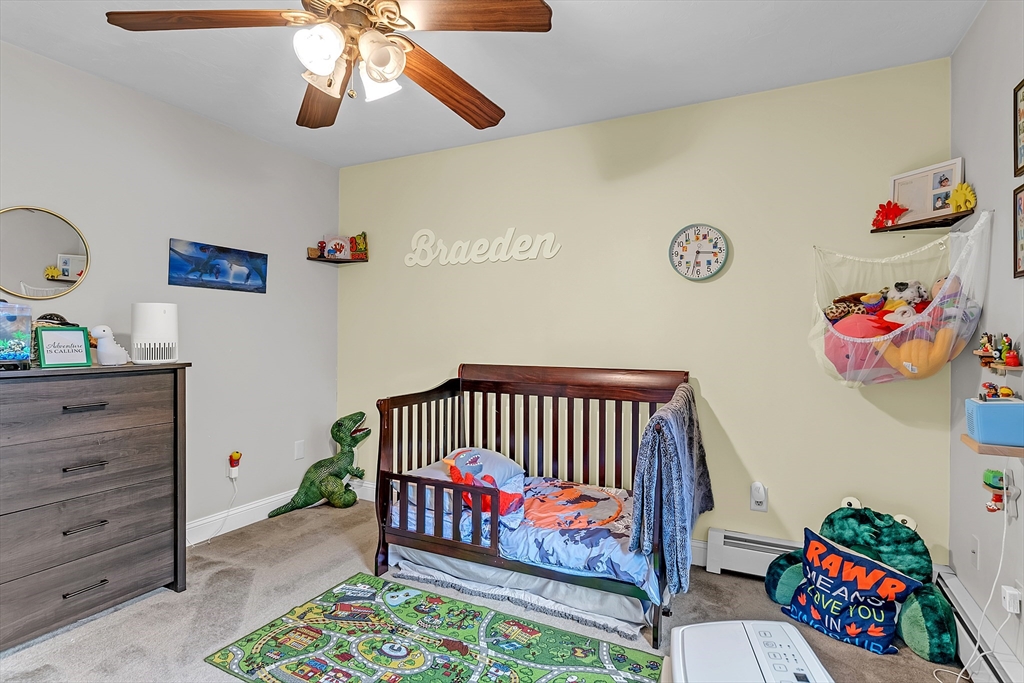 185 Bemis Road Warren, MA 01585 - Photo 24 of 36 a bedroom with a bed and a chandelier
