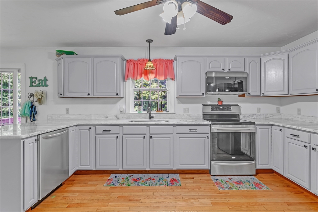 185 Bemis Road Warren, MA 01585 - Photo 3 of 36 a kitchen with kitchen island granite countertop a sink cabinets and window
