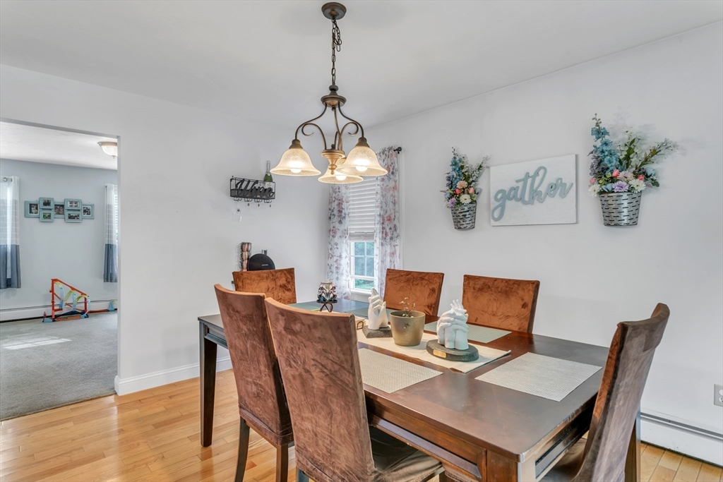 185 Bemis Road Warren, MA 01585 - Photo 9 of 36 a view of a dining room with furniture wooden floor and a chandelier