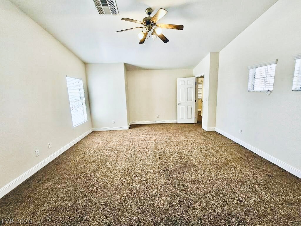5953 Crumbling Ridge Street Henderson, NV 89011 - Photo 18 of 42 A spacious bedroom provides a comfortable retreat with a cooling ceiling fan.