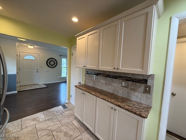 30101 Oakdale Road Willowick, OH 44095 - Photo 7 of 17 Kitchen featuring decorative backsplash, recessed lighting, dark stone countertops, light wood-type flooring, and white cabinetry