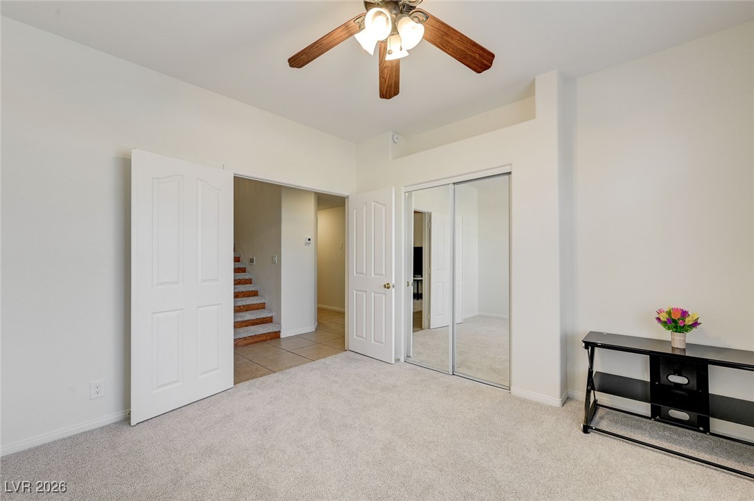 2955 El Camino Road Las Vegas, NV 89146 - Photo 43 of 99 Unfurnished bedroom with light carpet, ceiling fan, and a closet