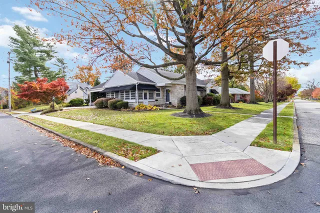front view of a house with a yard and potted plants