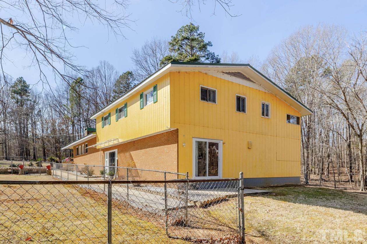 8200 McKee Road Rougemont, NC 27572 - Photo 11 of 32 a blue and white building with a outdoor space