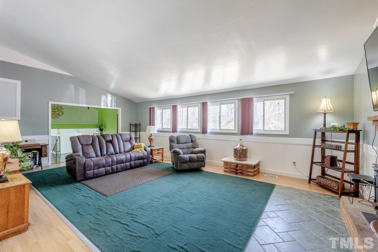 8200 McKee Road Rougemont, NC 27572 - Photo 12 of 32 a living room with furniture and a wooden floor