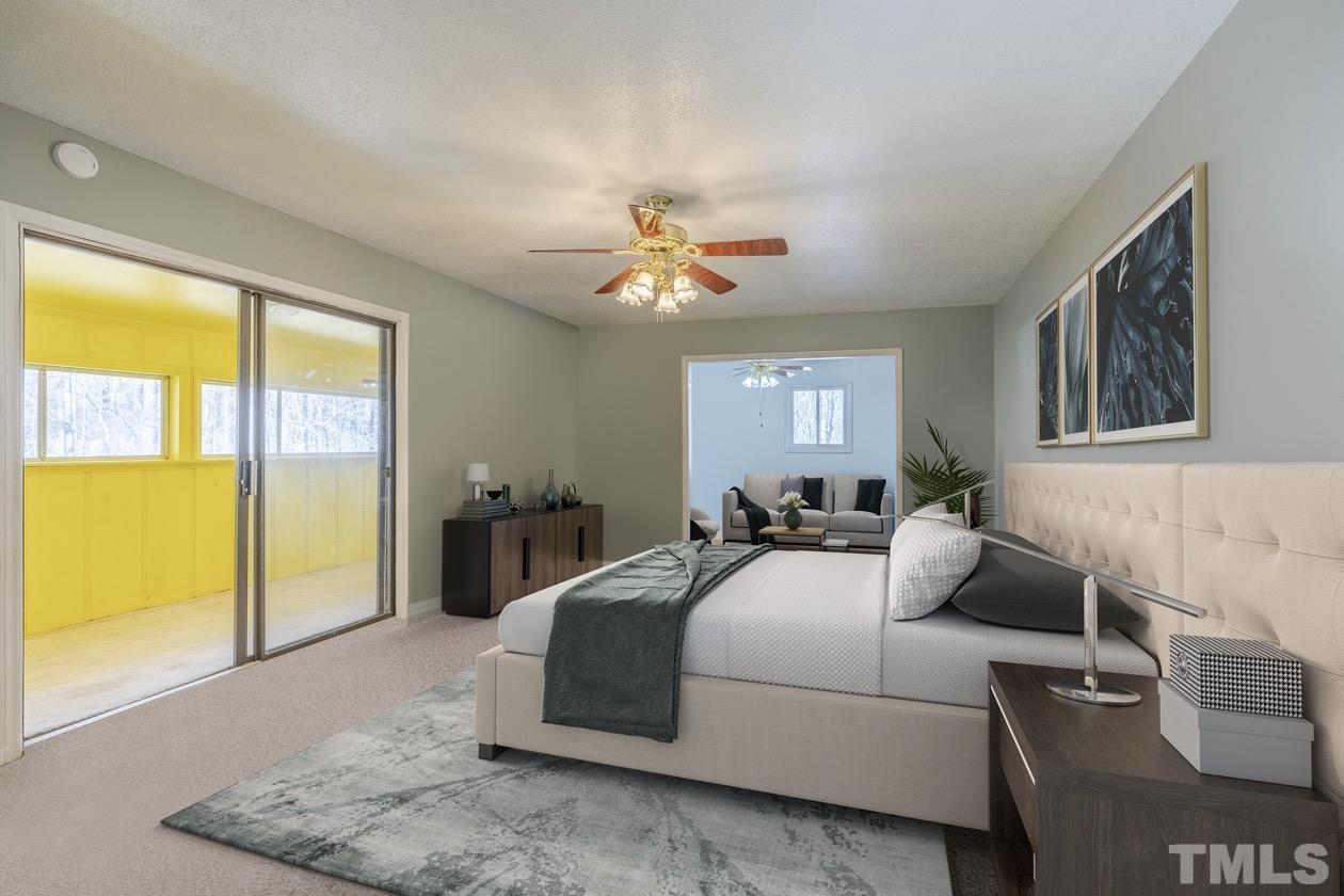 8200 McKee Road Rougemont, NC 27572 - Photo 23 of 32 a bedroom with a bed and a chandelier
