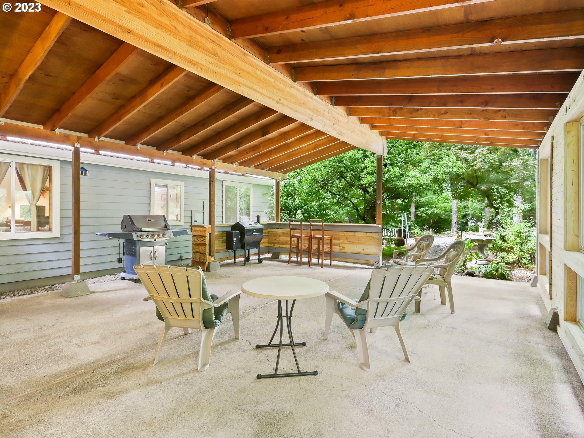 25875 South Morgan Road Estacada, OR 97023 - Photo 27 of 36 a view of a patio with a table chairs and a backyard