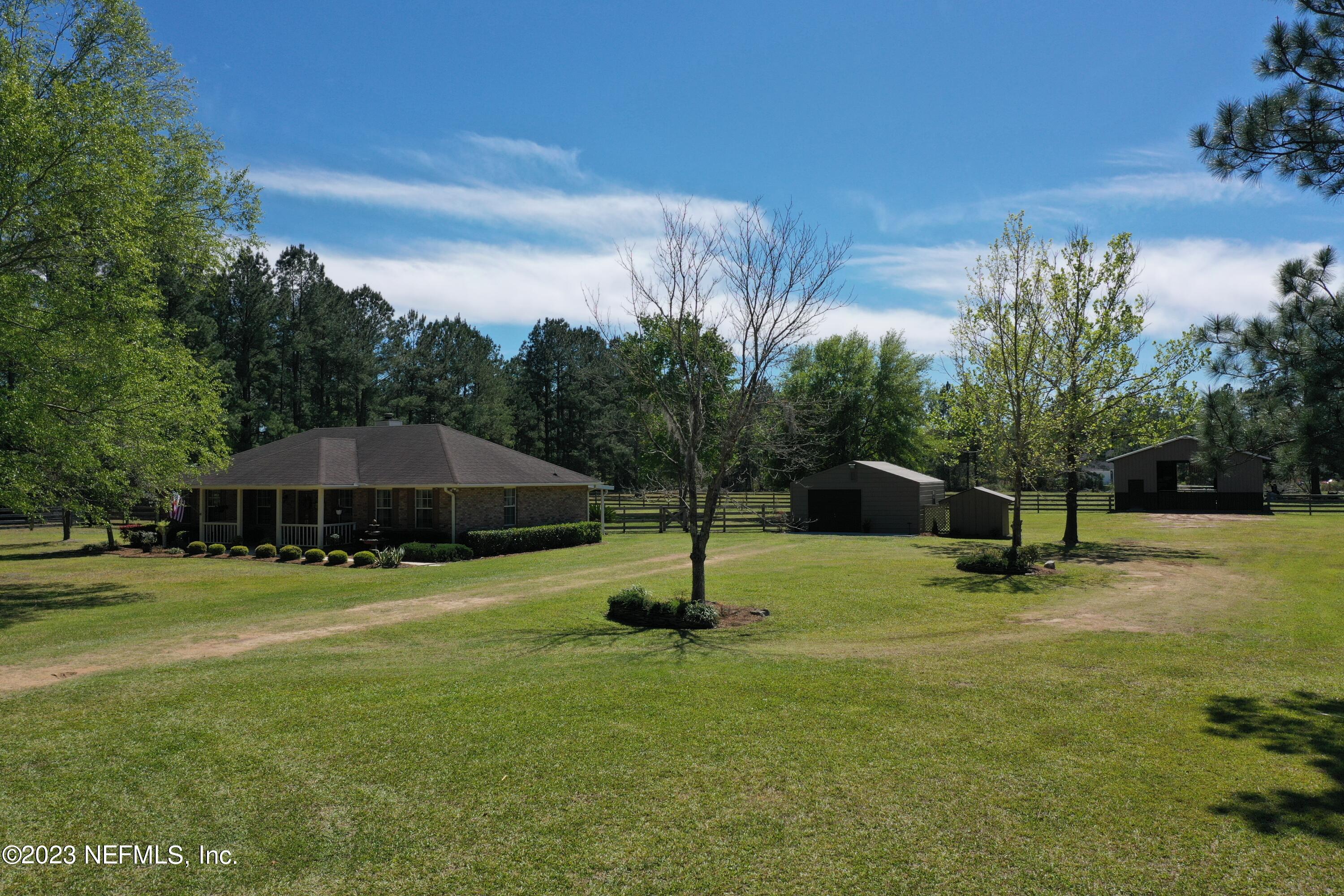 37491 Poole Road Hilliard, FL 32046 - Photo 11 of 39 a garden with trees in the background