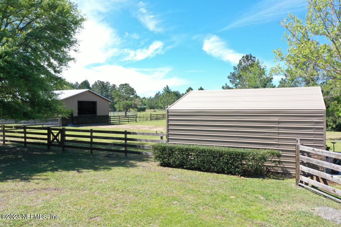 37491 Poole Road Hilliard, FL 32046 - Photo 13 of 39 a view of a swimming pool with a garden