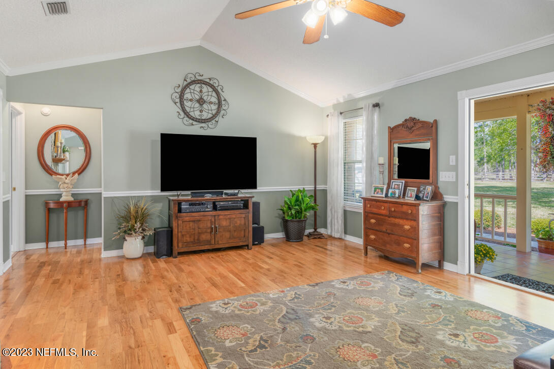 37491 Poole Road Hilliard, FL 32046 - Photo 17 of 39 a living room with furniture and a flat screen tv