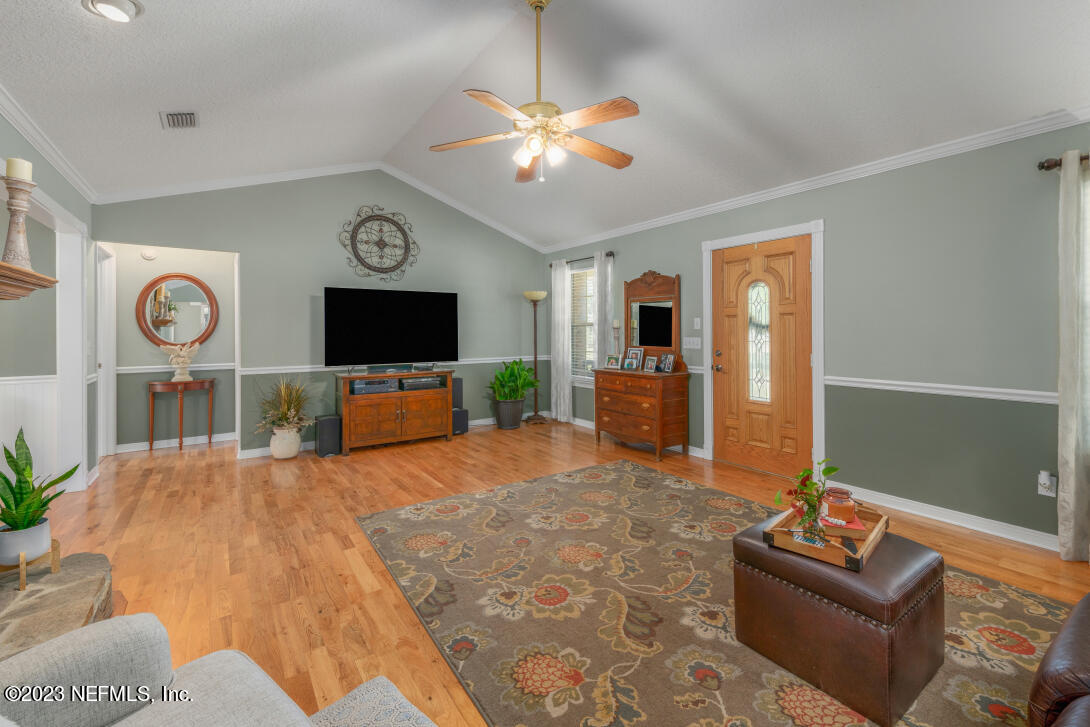 37491 Poole Road Hilliard, FL 32046 - Photo 18 of 39 a living room with furniture and a flat screen tv