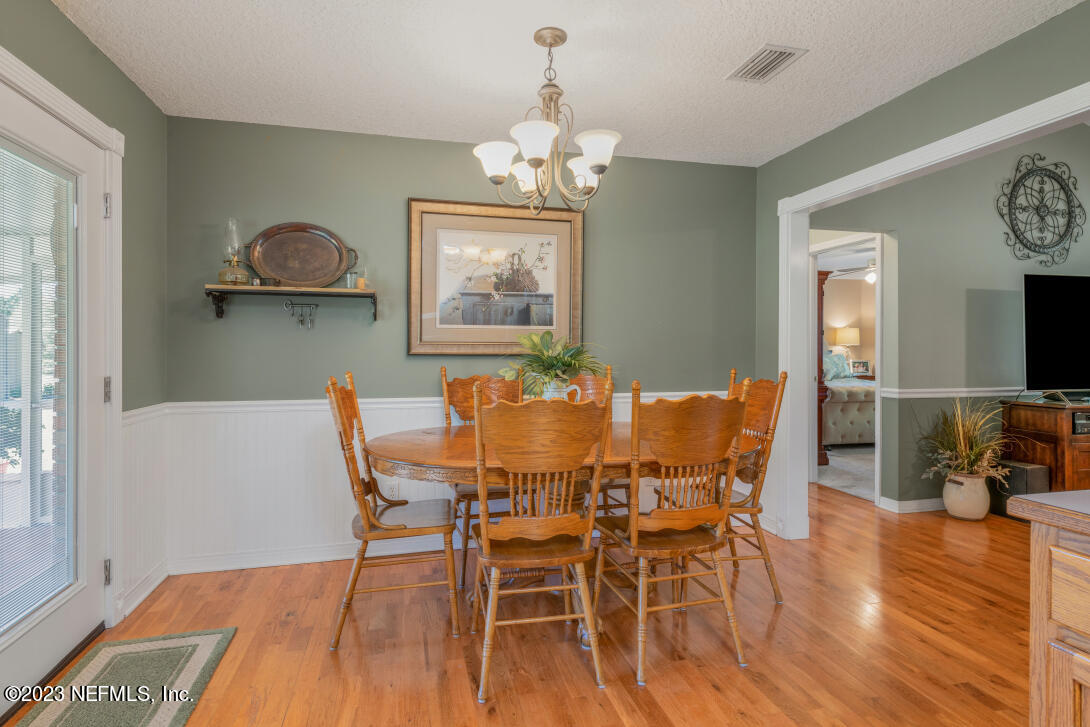 37491 Poole Road Hilliard, FL 32046 - Photo 20 of 39 a view of a dining room with furniture wooden floor and chandelier