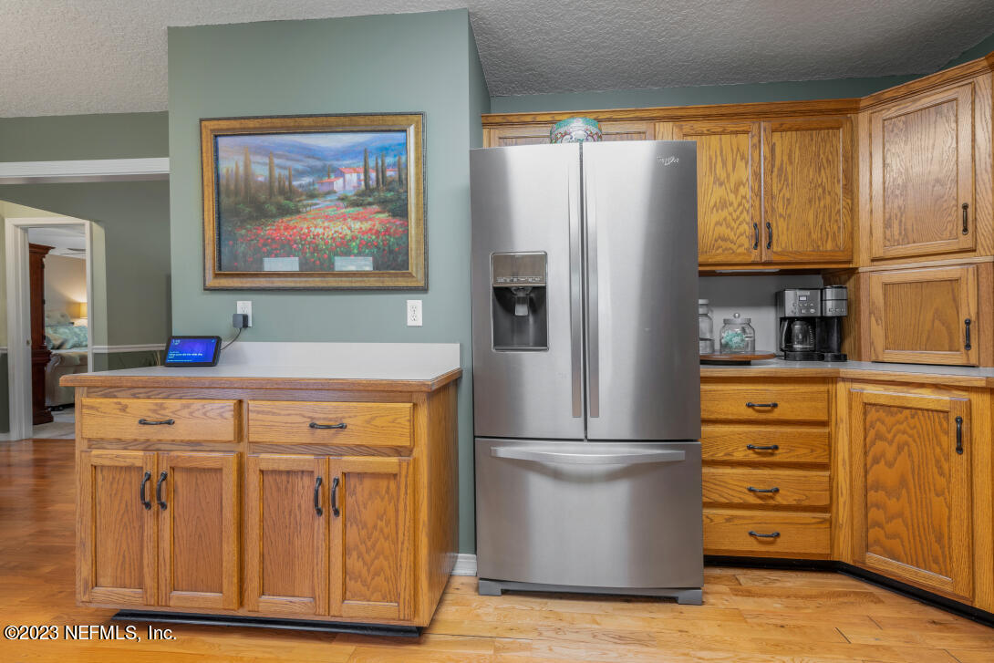 37491 Poole Road Hilliard, FL 32046 - Photo 22 of 39 a kitchen with stainless steel appliances granite countertop a refrigerator and a sink