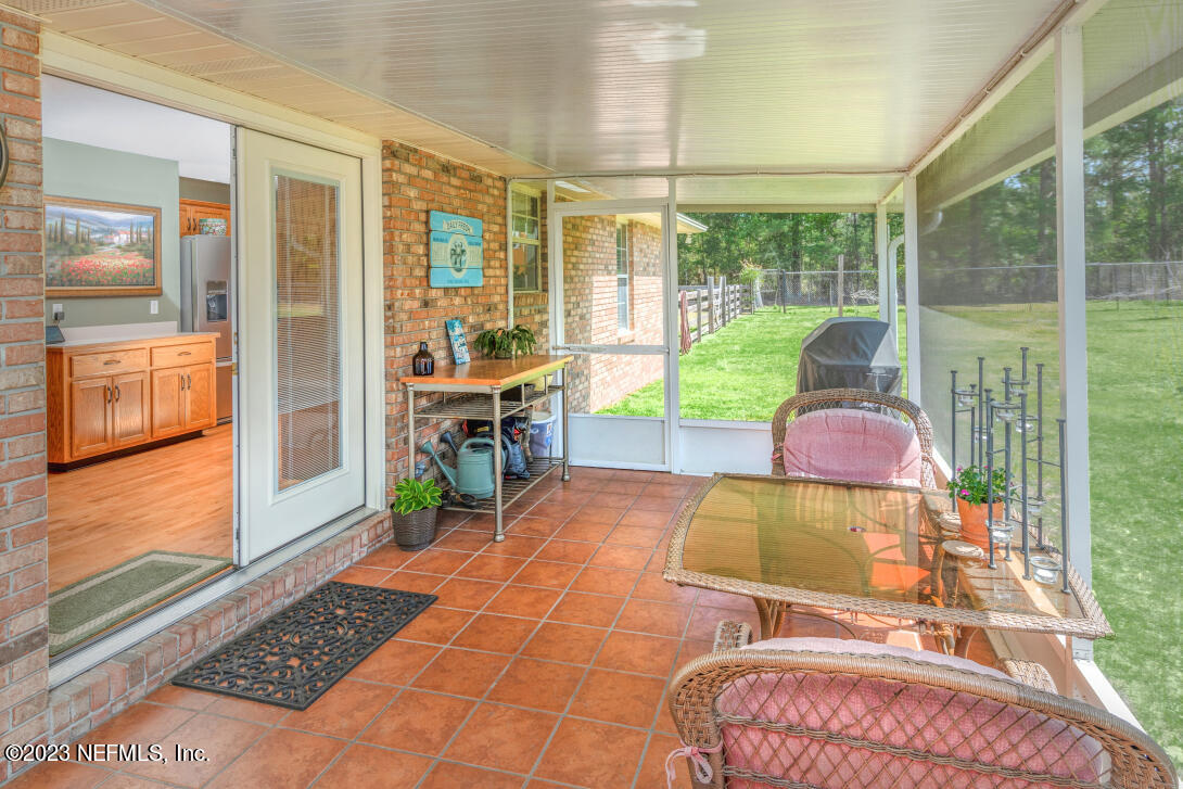 37491 Poole Road Hilliard, FL 32046 - Photo 24 of 39 a living room filled with furniture and a table