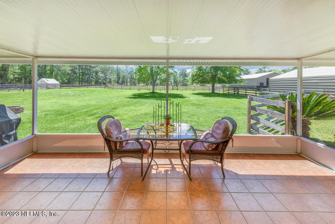 37491 Poole Road Hilliard, FL 32046 - Photo 25 of 39 a view of a patio with dining table and chairs