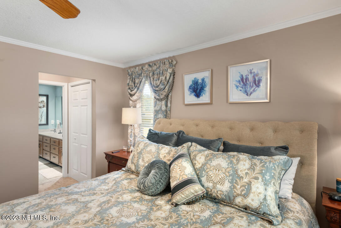 37491 Poole Road Hilliard, FL 32046 - Photo 28 of 39 a bedroom with a bed and wooden floor