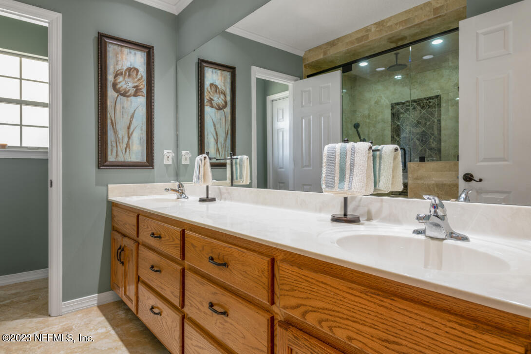 37491 Poole Road Hilliard, FL 32046 - Photo 29 of 39 a bathroom with double vanity sinks and a mirror