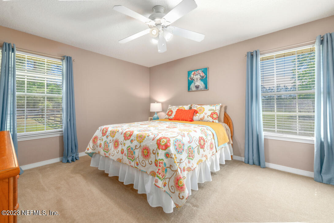 37491 Poole Road Hilliard, FL 32046 - Photo 31 of 39 a bed sitting in a bedroom next to a window