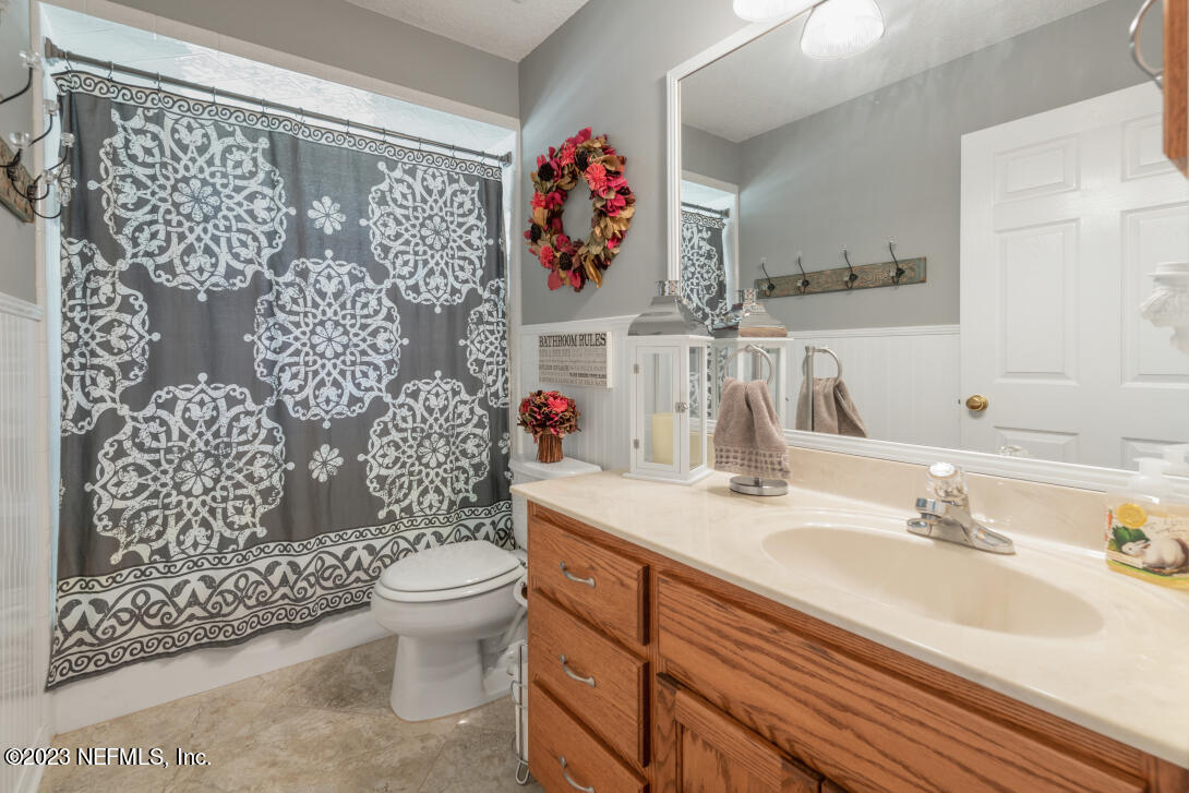 37491 Poole Road Hilliard, FL 32046 - Photo 33 of 39 a bathroom with a sink mirror vanity and toilet