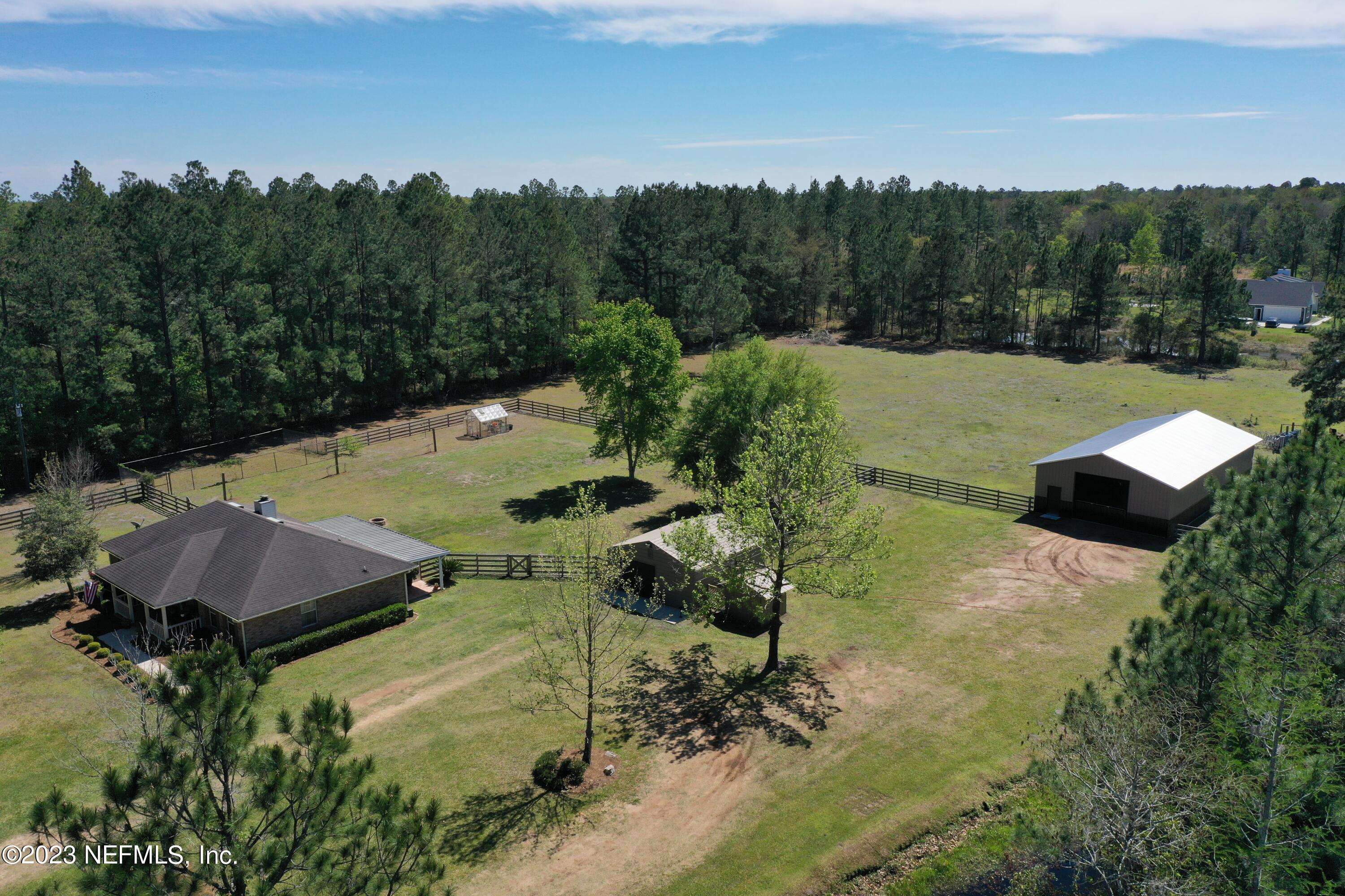 37491 Poole Road Hilliard, FL 32046 - Photo 10 of 39 a view of a swimming pool with a yard