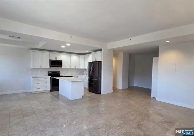 a view of a kitchen with refrigerator and microwave