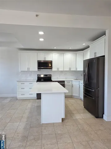 a kitchen with cabinets and stainless steel appliances