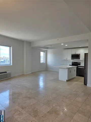 a view of kitchen with sink cabinets and window