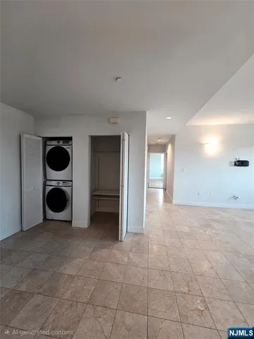 a view of an empty room with closet and a window