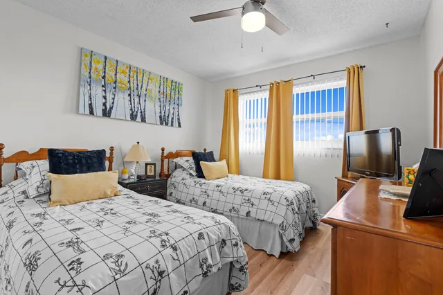 a bedroom with two beds and a chandelier
