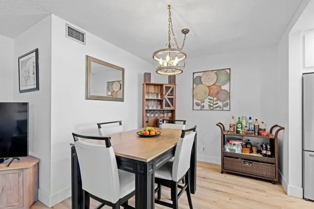 a view of a dining room with furniture wooden floor and a chandelier