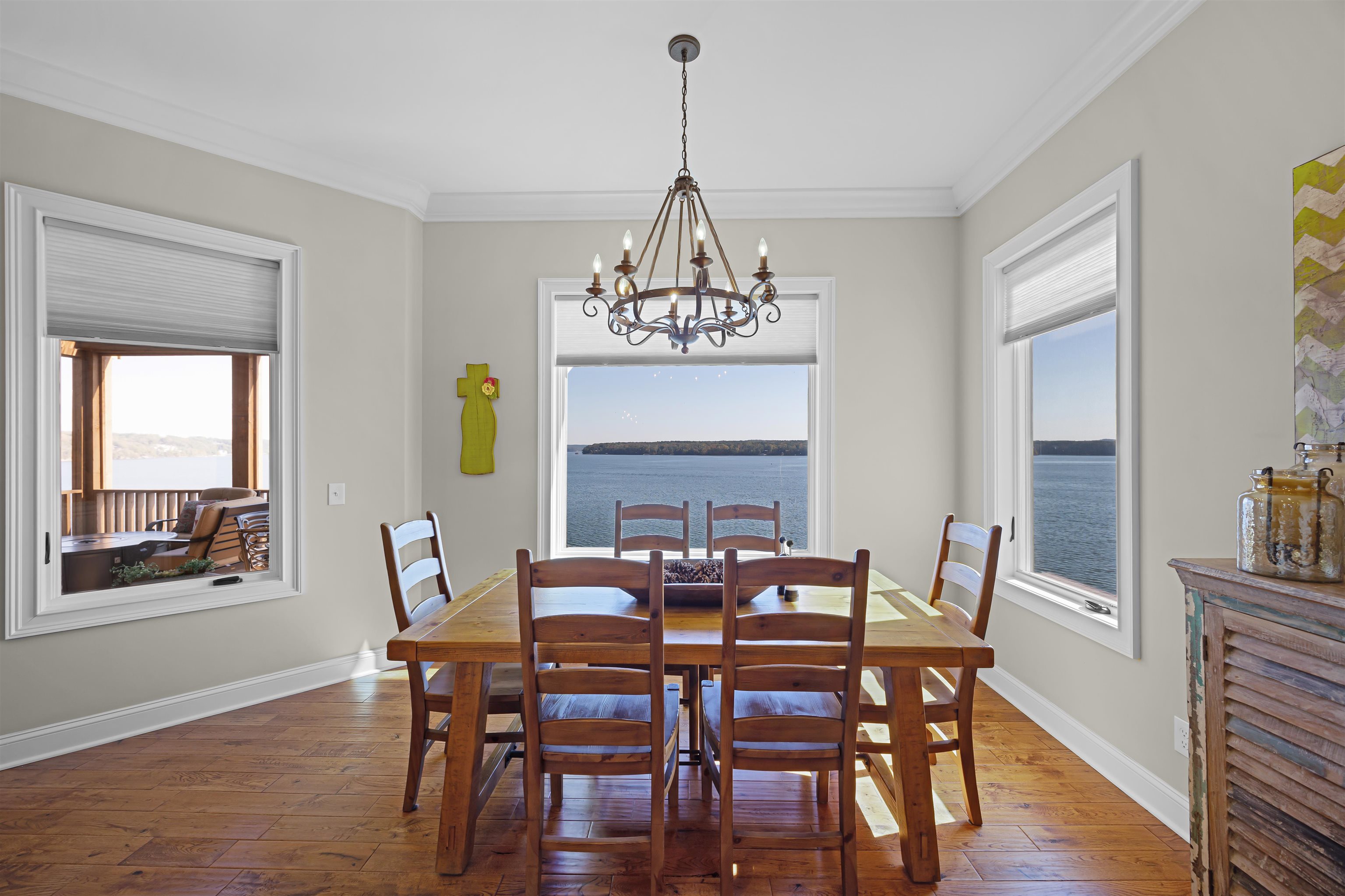45 Pinnacle Pointe Savannah, TN 38372 - Photo 15 of 30 Dining area with a chandelier, dark wood-style flooring, and ornamental molding and amazing view of the lake!
