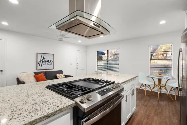 a stove top oven sitting inside of a kitchen