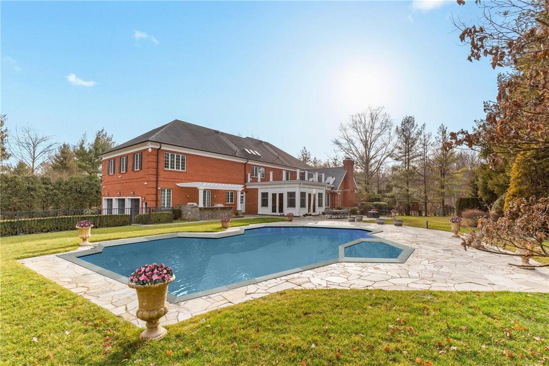 23 Beverly Road Purchase, NY 10577 - Photo 1 of 1 a view of pool with umbrella and wooden fence