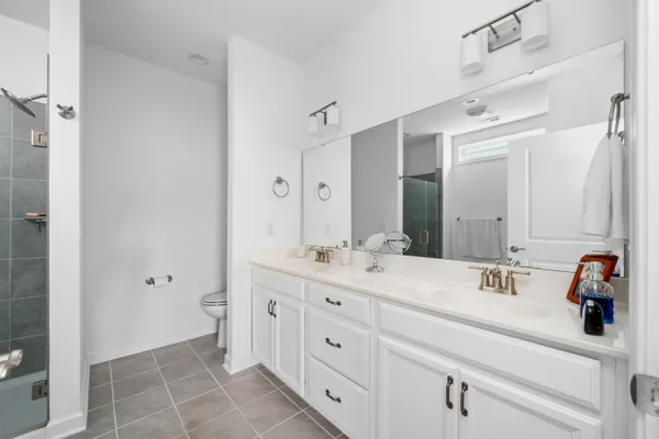 a bathroom with a double vanity sink mirror and