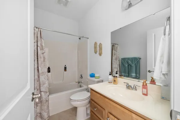 a bathroom with a sink toilet vanity and shower