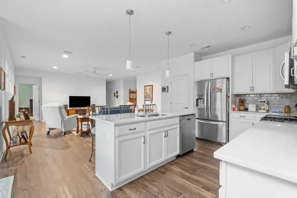 a kitchen with stainless steel appliances a refrigerator sink and microwave