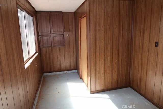 a view of a livingroom with wooden floor and a window