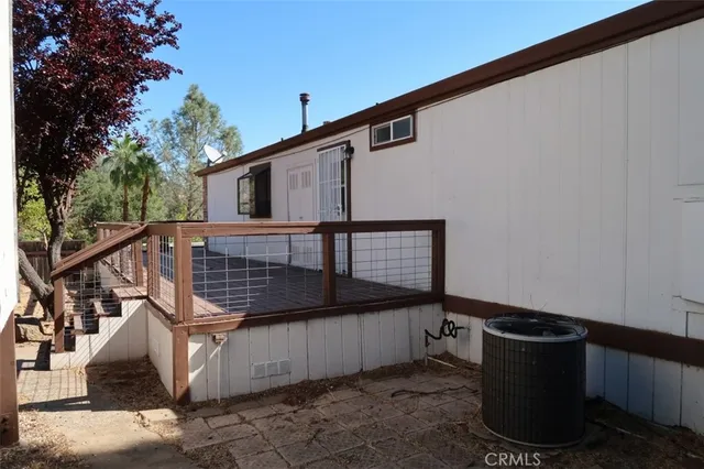 a view of balcony with wooden floor and fence