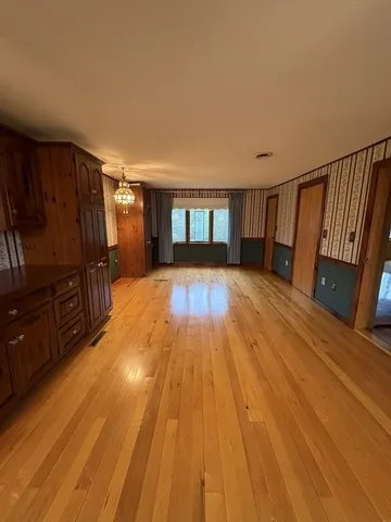 a view of a living room with wooden floor