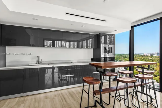 a kitchen with a table chairs sink and cabinets