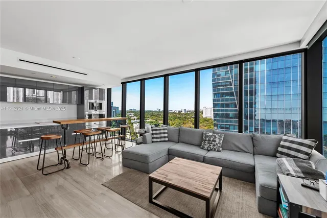a living room with furniture and a large window