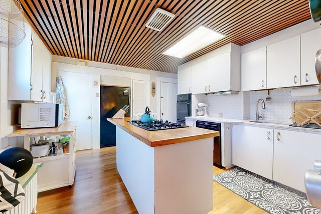 a kitchen with a stove a sink and a refrigerator