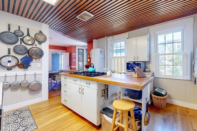 a large kitchen with stainless steel appliances granite countertop a sink and a cabinets
