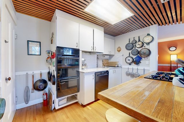 a kitchen with stainless steel appliances granite countertop a stove and a refrigerator