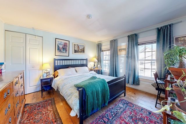 a bed room with a bed and a chair