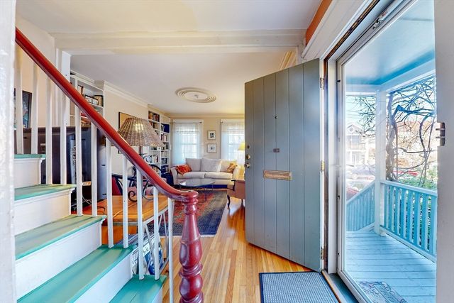 a view of an entryway with wooden floor and stairs